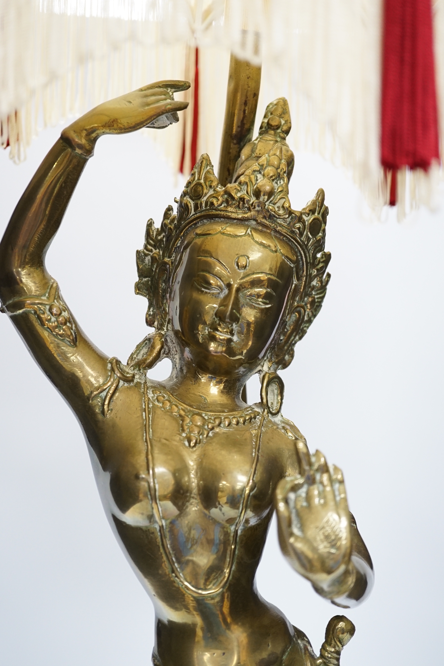A vintage Indian polished brass figure of a dancer on lotus base, now mounted as a lamp, 80cm including shade